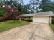 Charming single-story home with a well-manicured lawn, mature tree, and a long driveway at 2060 Devore Sw Dr, Marietta, GA 30008