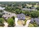 Stunning aerial view of waterfront property with lush landscaping, golf course in background at 2837 Darlington Run, Duluth, GA 30097