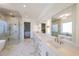 A spacious bathroom features double sinks, white cabinets, marble counters, and a walk-in shower at 2837 Darlington Run, Duluth, GA 30097