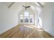 Bright bedroom with large windows, hardwood floors, a ceiling fan, and white trim at 2837 Darlington Run, Duluth, GA 30097
