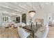 Open-concept dining area featuring hardwood floors, coffered ceiling, chandelier, and natural light at 2837 Darlington Run, Duluth, GA 30097