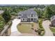 Beautiful home exterior with well-manicured lawn, brick driveway and water view at 2837 Darlington Run, Duluth, GA 30097