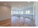 Bright hallway boasts hardwood floors, black wrought iron railing, and ample natural light from surrounding windows at 2837 Darlington Run, Duluth, GA 30097