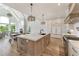 Bright kitchen with center island, marble countertops, hardwood floors, and modern lighting at 2837 Darlington Run, Duluth, GA 30097