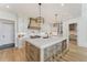 Elegant kitchen featuring a large island with seating, marble countertops, and stainless steel appliances at 2837 Darlington Run, Duluth, GA 30097