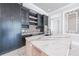 Modern kitchen with dark cabinets, marble countertop island, and stainless steel appliances at 2837 Darlington Run, Duluth, GA 30097