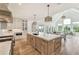 Bright kitchen with island, marble countertops, stainless appliances, adjoining living room and vaulted ceiling at 2837 Darlington Run, Duluth, GA 30097