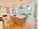 Open concept features a kitchen with a center island, a dining area, and a great room at 2837 Darlington Run, Duluth, GA 30097
