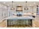 Bright kitchen features a marble island with seating, custom cabinetry, and designer pendant lighting at 2837 Darlington Run, Duluth, GA 30097