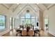 Open concept features a dining area and living room with soaring ceilings and a wall of windows at 2837 Darlington Run, Duluth, GA 30097