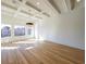 Open living room with coffered ceilings, hardwood flooring, and large windows at 2837 Darlington Run, Duluth, GA 30097