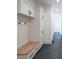 Hallway mudroom with built-in bench, storage cabinets, coat hooks, and dark tile flooring at 2837 Darlington Run, Duluth, GA 30097