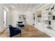 Bright home office featuring custom built-ins, decorative artwork, and stylish blue furniture at 2837 Darlington Run, Duluth, GA 30097