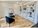 Bright office with custom built-in shelving, modern decor, and hardwood floors at 2837 Darlington Run, Duluth, GA 30097