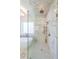 Close-up of a glass shower with elegant marble tiling, rainfall shower head, and built-in niche at 2837 Darlington Run, Duluth, GA 30097
