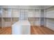 Spacious walk-in closet with custom shelving, drawers, and a center island for storage at 2837 Darlington Run, Duluth, GA 30097