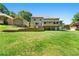 Large backyard featuring a well-kept lawn and view of rear home elevation at 4826 Dean Sw Ln, Lilburn, GA 30047