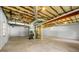 Spacious unfinished basement with exposed ductwork and concrete flooring at 4826 Dean Sw Ln, Lilburn, GA 30047