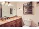 Bathroom with granite counters, vanity cabinet, decorative mirror and toilet at 4826 Dean Sw Ln, Lilburn, GA 30047