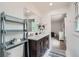Bright bathroom with double vanity, wall mirror, toilet, and modern fixtures at 4826 Dean Sw Ln, Lilburn, GA 30047