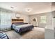 Spacious primary bedroom featuring a carpeted floor, natural light, and a modern design at 4826 Dean Sw Ln, Lilburn, GA 30047