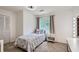 Cozy bedroom with a large window, a twin bed, and warm neutral colors at 4826 Dean Sw Ln, Lilburn, GA 30047
