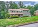 Charming two-story home with stone accents and a well-manicured front yard at 4826 Dean Sw Ln, Lilburn, GA 30047