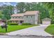 Inviting two-story home with a long driveway leading to a detached garage at 4826 Dean Sw Ln, Lilburn, GA 30047