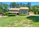 Inviting home showcasing a manicured lawn, stone porch, and detached garage at 4826 Dean Sw Ln, Lilburn, GA 30047