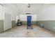 Neat garage with a neutral palette, storage options, and concrete flooring at 4826 Dean Sw Ln, Lilburn, GA 30047