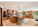 Bright kitchen features a large island with seating, stainless appliances, wood cabinets and wood flooring at 4826 Dean Sw Ln, Lilburn, GA 30047