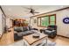 Open-concept living room featuring hardwood floors, natural light and comfortable seating at 4826 Dean Sw Ln, Lilburn, GA 30047