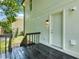 Back door on the wooden deck features an outdoor light and white paint at 5250 Forest Downs Ln, Atlanta, GA 30349