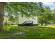 View of the back of the white, two story house featuring a large, grassy lawn at 5250 Forest Downs Ln, Atlanta, GA 30349