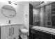 Modern bathroom with a vanity, toilet and a shower over tub with glass doors and a mosaic tile feature wall at 5250 Forest Downs Ln, Atlanta, GA 30349