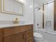 Bathroom featuring a wood vanity with gold fixtures and a shower-tub combo at 5250 Forest Downs Ln, Atlanta, GA 30349