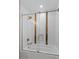 This bathroom has a shower-tub combo with glass doors and tile accents at 5250 Forest Downs Ln, Atlanta, GA 30349