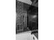 Close up view of the shower over tub with glass doors and a mosaic tile feature wall at 5250 Forest Downs Ln, Atlanta, GA 30349