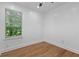 Bedroom with hardwood floors, a ceiling fan, and natural light from a window at 5250 Forest Downs Ln, Atlanta, GA 30349