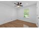 This bedroom offers a ceiling fan and a large window providing ample natural light at 5250 Forest Downs Ln, Atlanta, GA 30349