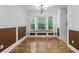 Formal dining room featuring a bay window, hardwood floors, and classic trim at 5250 Forest Downs Ln, Atlanta, GA 30349