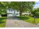 Charming two-story home with a blue front door, a large front yard, and a long driveway at 5250 Forest Downs Ln, Atlanta, GA 30349
