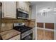 Modern kitchen features stainless steel appliances, stone countertops and lighting at 5250 Forest Downs Ln, Atlanta, GA 30349