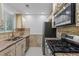 Bright kitchen featuring stainless steel appliances, stone countertops, and a window at 5250 Forest Downs Ln, Atlanta, GA 30349