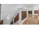 Staircase and living room with beautiful hardwood floors and stone fireplace at 5250 Forest Downs Ln, Atlanta, GA 30349