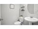 Cozy half-bathroom with pedestal sink, decorative shelves and pleasant decor at 130 Bingley Ct, Covington, GA 30016