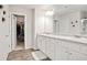Bright bathroom featuring double sinks, lots of counter space and a view of a walk-in closet at 130 Bingley Ct, Covington, GA 30016