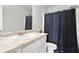 The bathroom features a granite countertop vanity and a shower with a dark shower curtain at 130 Bingley Ct, Covington, GA 30016