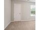 This bedroom is flooded with natural light from the window and features neutral paint and carpet at 130 Bingley Ct, Covington, GA 30016