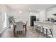 Bright dining area with a chandelier, bar stools, and natural light at 130 Bingley Ct, Covington, GA 30016